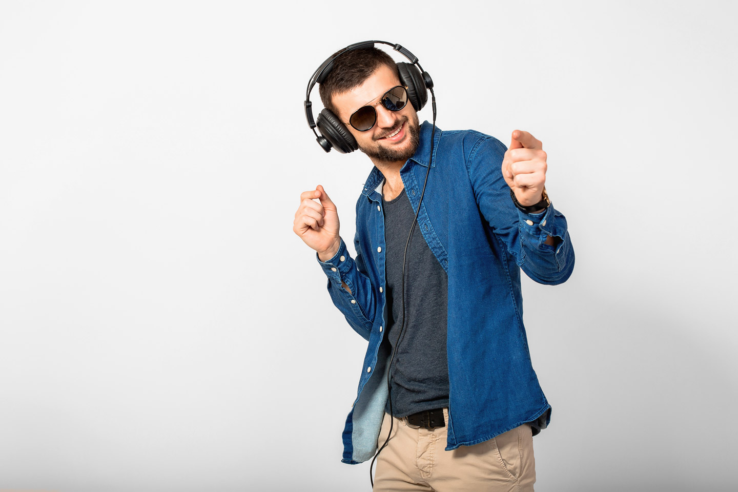 young-handsome-happy-smiling-man-dancing-listening-music-headphones-isolated-white-studio-wall